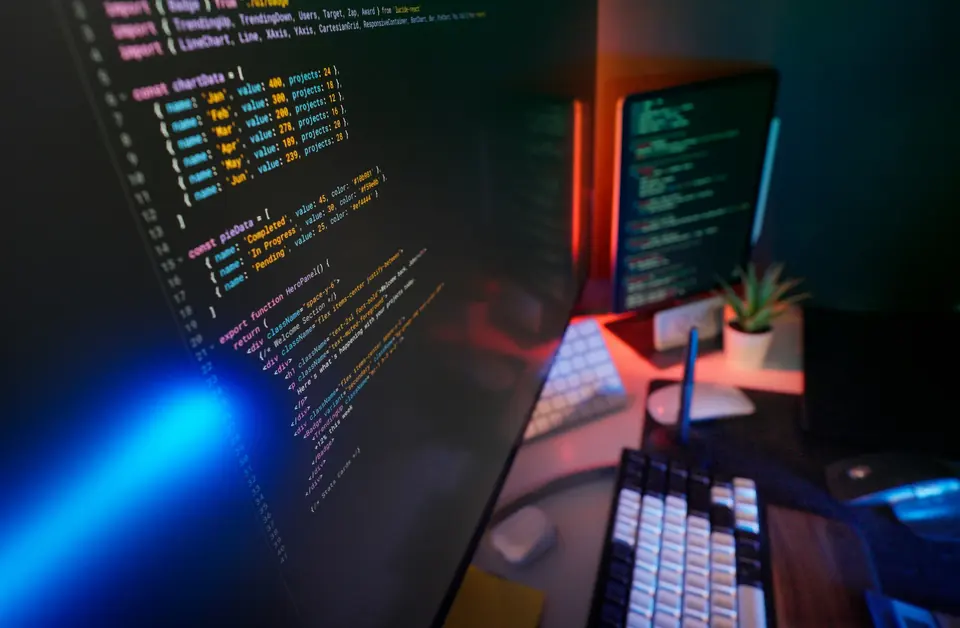 Software engineering code displayed across multiple workstation screens